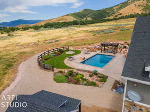 View of pool with a gazebo, a mountain view, and a patio