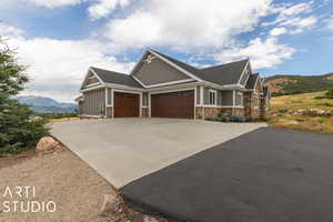 Craftsman inspired home with a mountain view and a garage