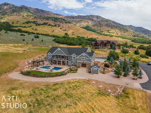 Rear view of house with a mountain view and a garage
