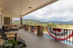 Wooden terrace with a mountain view and outdoor lounge area