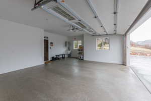 Garage with a garage door opener and a mountain view