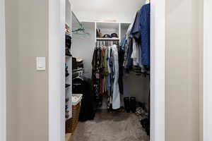 Walk in closet featuring carpet flooring