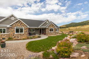 Craftsman house featuring a mountain view and a front lawn
