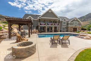 View of swimming pool with an outdoor fire pit, a pergola, a mountain view, and a patio area