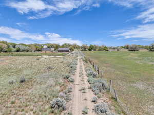 View of yard with fence and a rural view