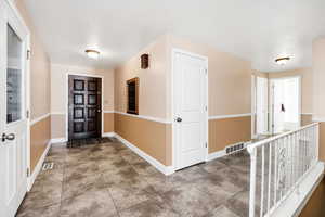 Entryway featuring visible vents and baseboards