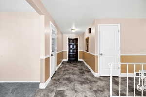 Entryway with baseboards and visible vents