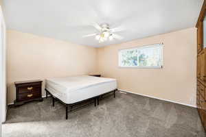 Bedroom with baseboards, carpet, and ceiling fan