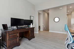 Office featuring baseboards, recessed lighting, and light wood-type flooring