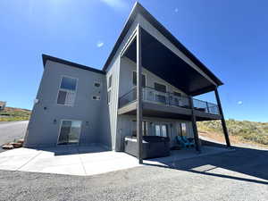 Back of house with entrance to lower level master
