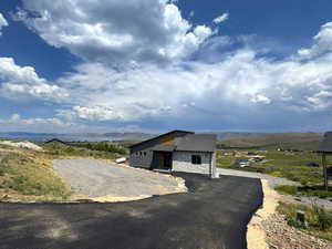 View of front of property with stone siding, a mountain view, and board and batten siding