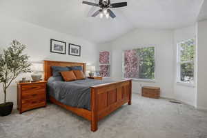 Bedroom featuring carpet flooring, lofted ceiling, baseboards, and a ceiling fan