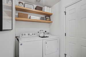 Washroom featuring washer and clothes dryer