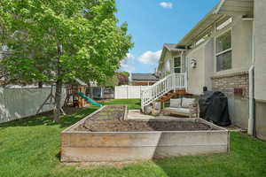 View of yard with a garden and a playground