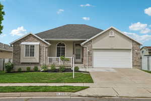 View of front of home with covered porch, a garage, stucco siding, concrete driveway, and a shingled roof
