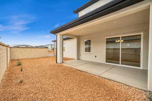 View of yard with a fenced backyard and a patio
