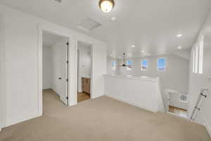Unfurnished room with baseboards, recessed lighting, attic access, and light carpet