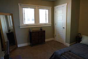 Carpeted bedroom featuring baseboards