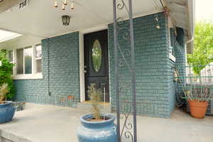Property entrance with brick siding and fence