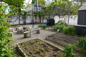 View of yard featuring a gazebo, a fenced backyard, a patio area, and a vegetable garden
