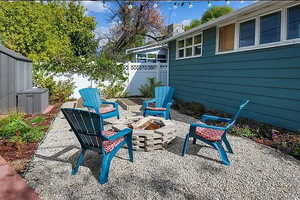 View of patio featuring fence and a fire pit