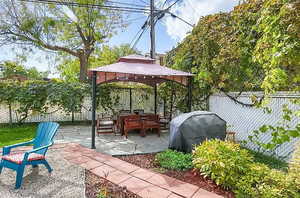 View of patio with a fenced backyard and a gazebo