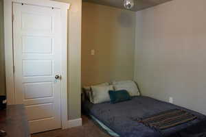 Carpeted bedroom featuring baseboards