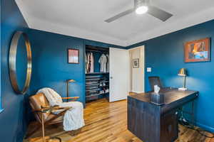 Office area featuring wood finished floors and ceiling fan