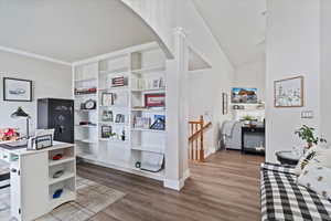Office featuring ornamental molding, wood finished floors, baseboards, and arched walkways