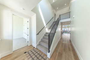 Stairs featuring laminate floors and recessed lighting