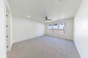 Spare room with recessed lighting, light colored carpet, and a ceiling fan