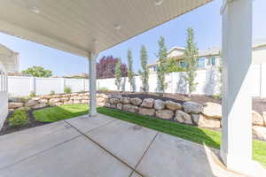 Fenced backyard with a patio