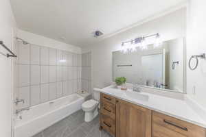 Full bath featuring vanity, shower / bathtub combination, and a textured ceiling