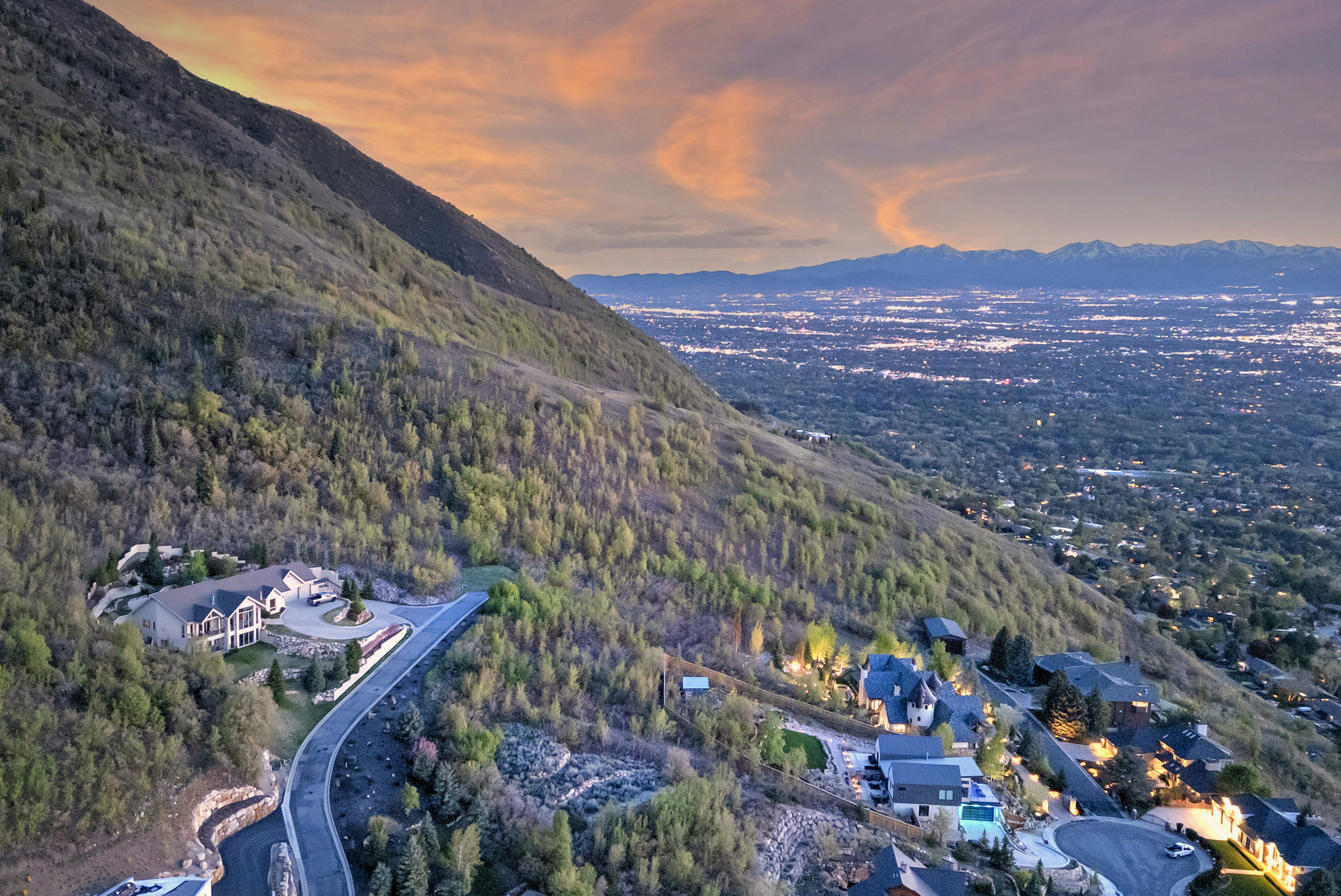 Aerial view at dusk with a mountain view and a wooded view