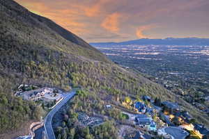 Aerial view at dusk with a mountain view and a wooded view