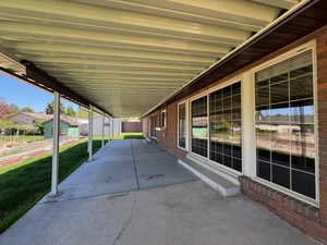 View of patio / terrace featuring entry steps, an outbuilding, and fence