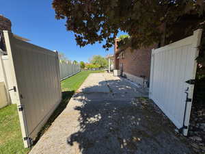 View of home's exterior with fence and a patio area
