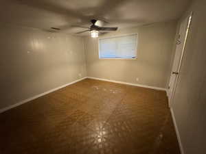 Unfurnished bedroom featuring tile patterned floors, a textured ceiling, baseboards, and a ceiling fan