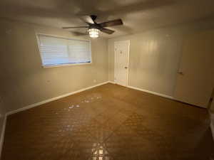 Spare room featuring ceiling fan, a textured ceiling, and baseboards