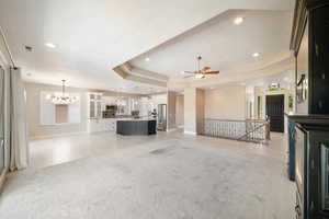 Unfurnished living room with visible vents, baseboards, ceiling fan with notable chandelier, and recessed lighting