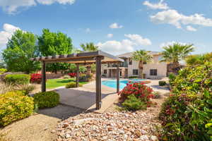 Outdoor pool featuring a ceiling fan, an in ground hot tub, fence, and a patio