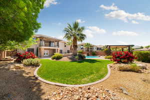 View of yard with french doors, a ceiling fan, fence, a balcony, and a fenced in pool