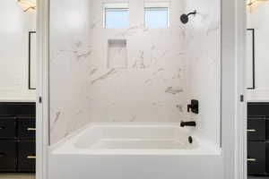 Bathroom featuring  shower combination and vanity