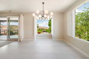 Interior space featuring a chandelier and baseboards