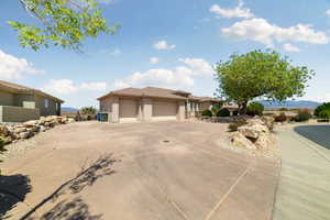 Prairie-style home featuring concrete driveway, stucco siding, and an attached garage