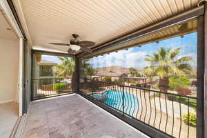 Balcony with a pool with connected hot tub and ceiling fan