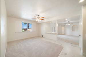Spare room with recessed lighting, baseboards, marble finish floor, ceiling fan, and light carpet