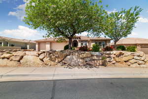 Ranch-style home with a garage and stucco siding
