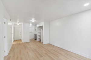 Interior space featuring baseboards, light wood finished floors, and visible vents