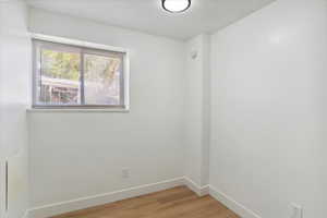 Unfurnished room featuring baseboards and light wood-type flooring